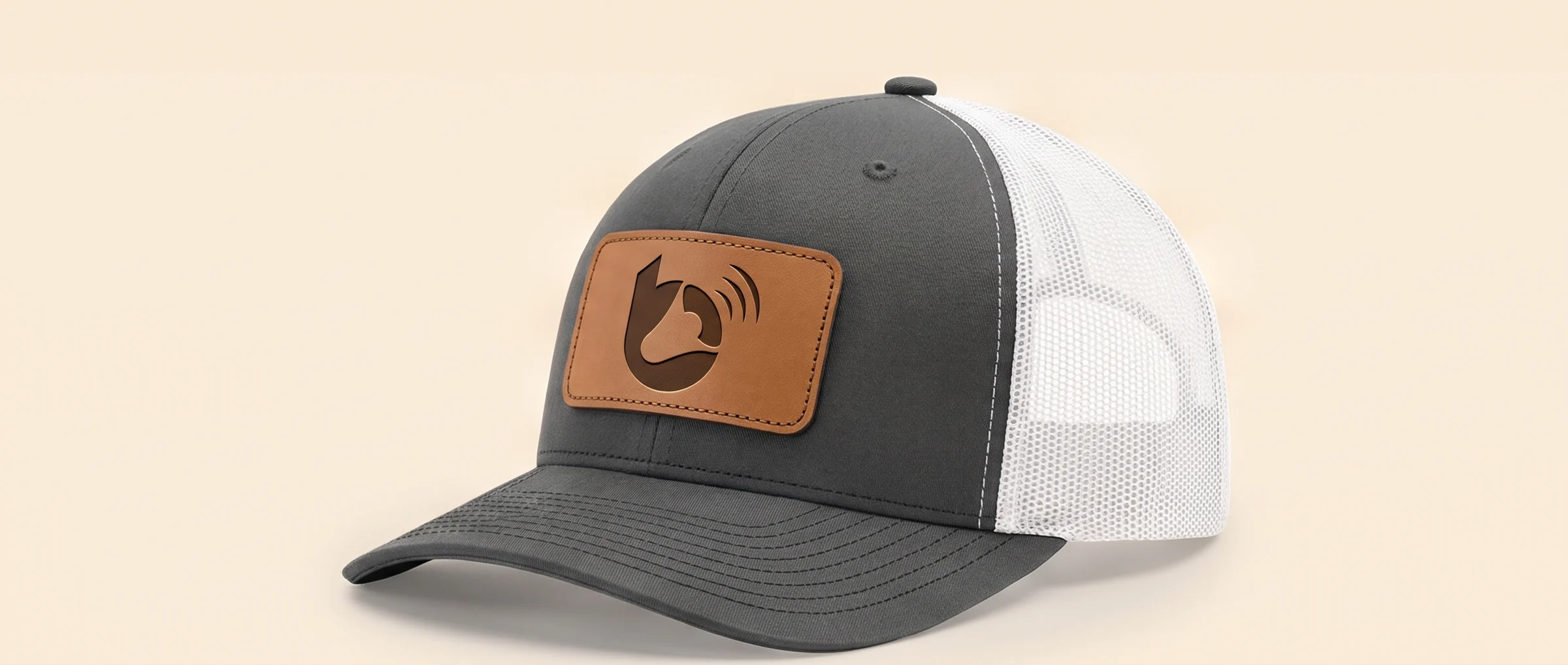 Charcoal Richardson trucker cap with the Brand Builder mark debossed in the leather patch